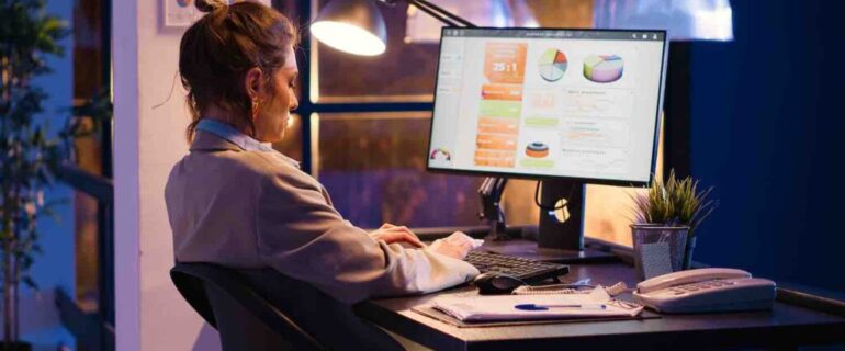 Female manager working on financial statistics in office Female manager working on financial statistics in office, analyzing marketing strategy and business growth on online report. Young woman looking at diagrams analytics to plan investment.